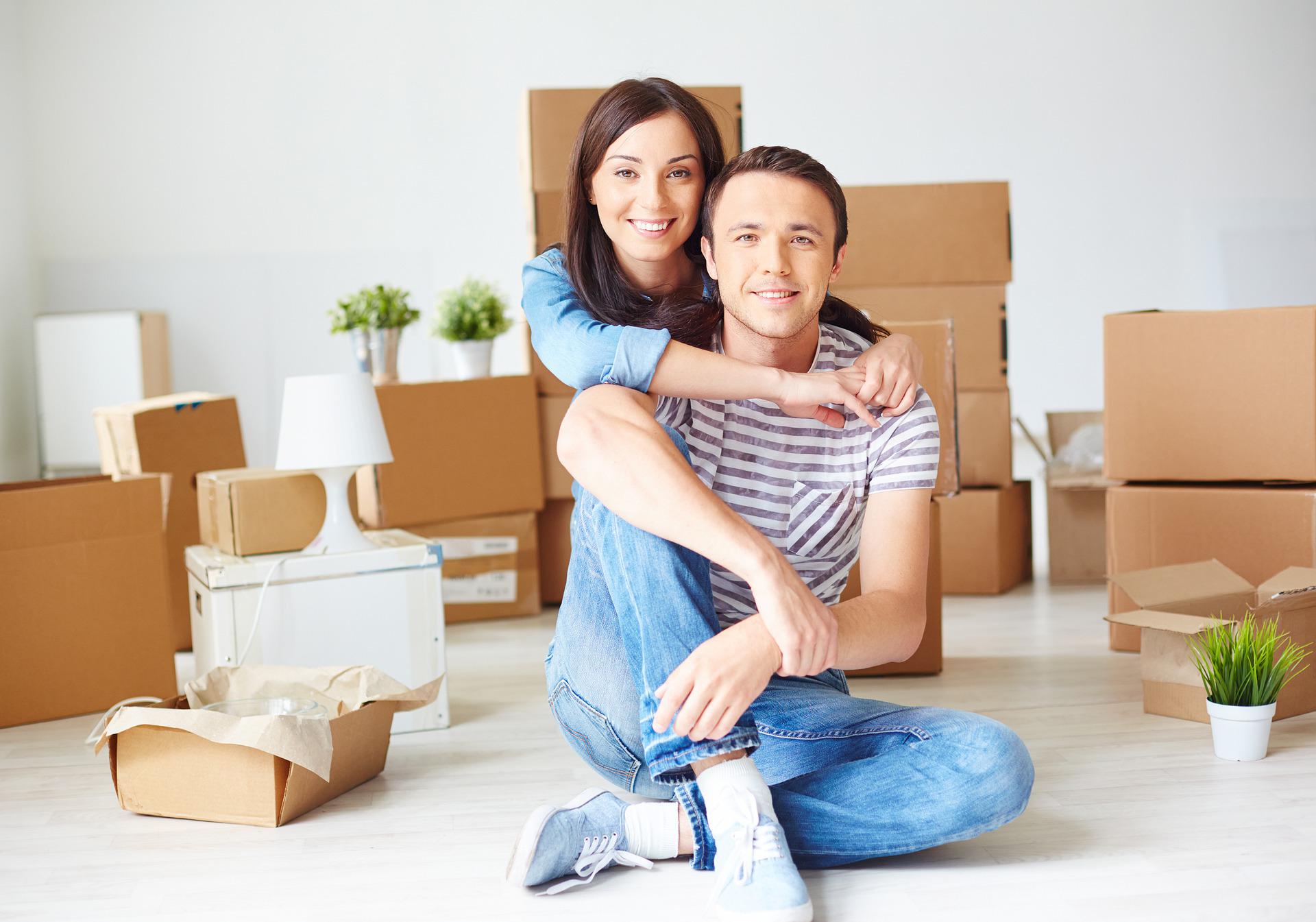 Couple Moving House with Boxes Around